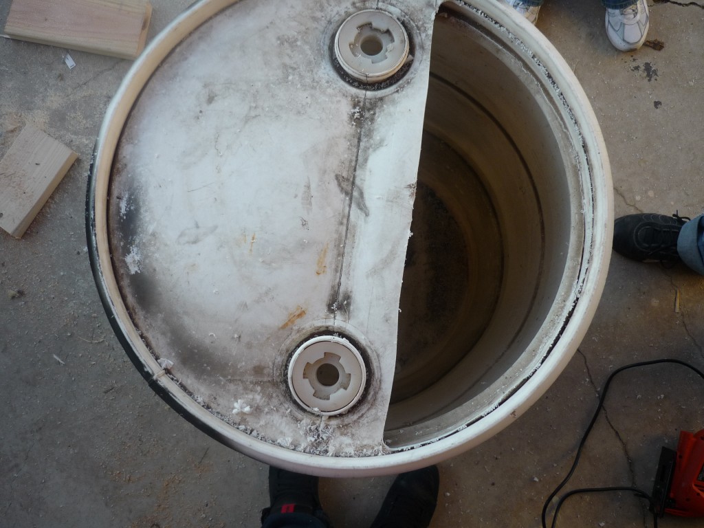 Original 2011 Garden Pool photograph of the curved opening being cut into the barrel with a jig saw