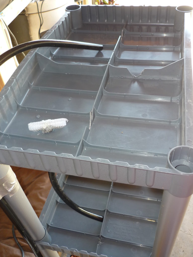 Original Garden Pool photograph of the assembled Shelfponics unit with barbed T drains installed and channels cut between the shelf quadrants