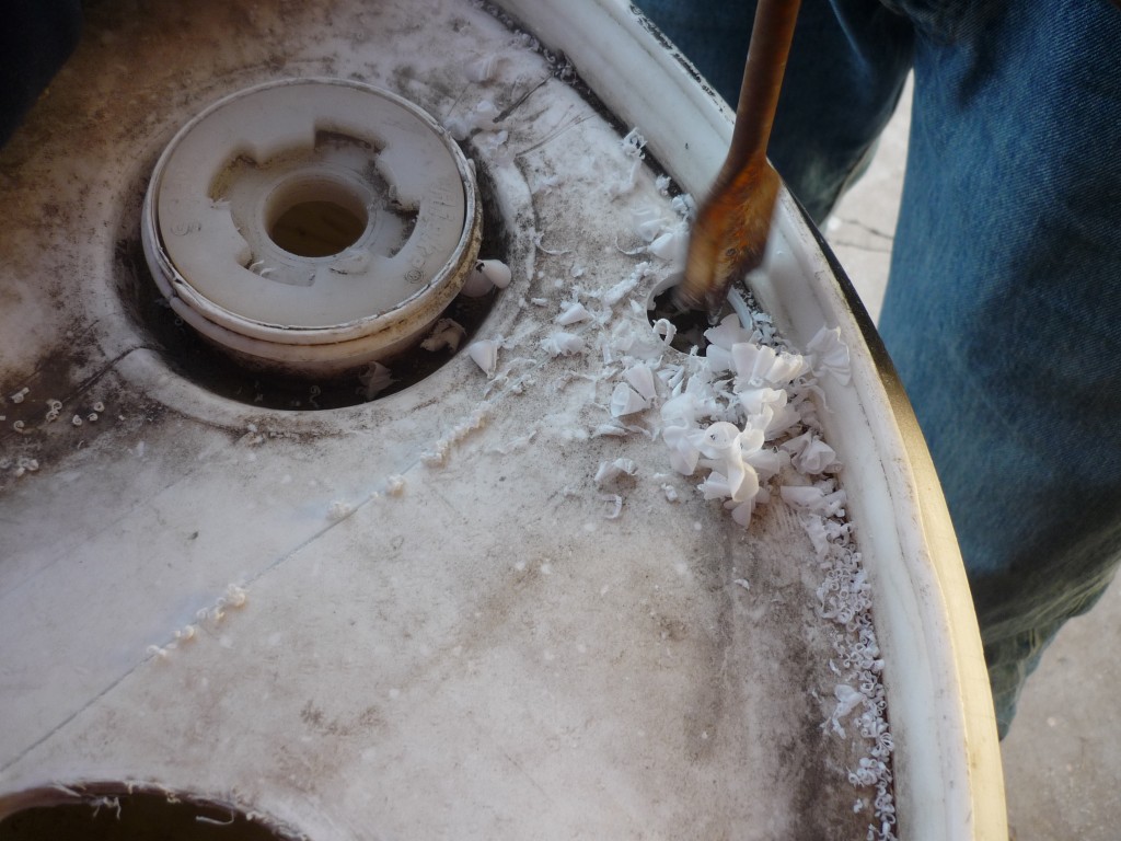 Original 2011 Garden Pool photograph of a hole being drilled into the blue plastic barrel