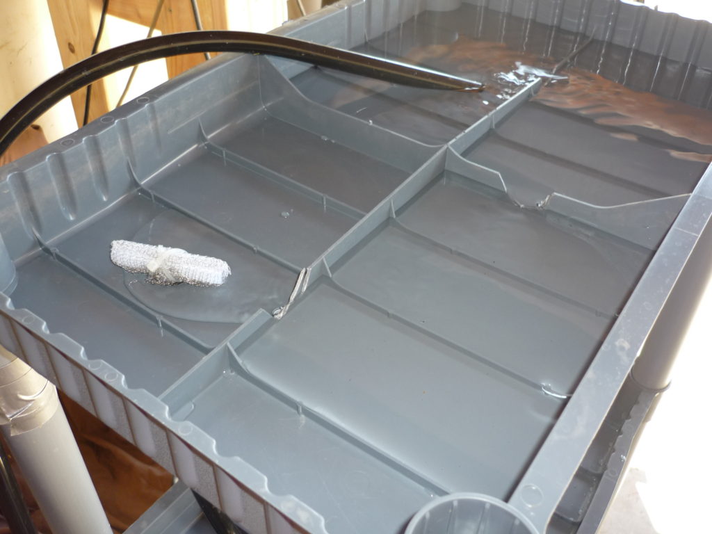 Original Garden Pool photograph of water flowing across an inverted shelf tray from one quadrant into the next