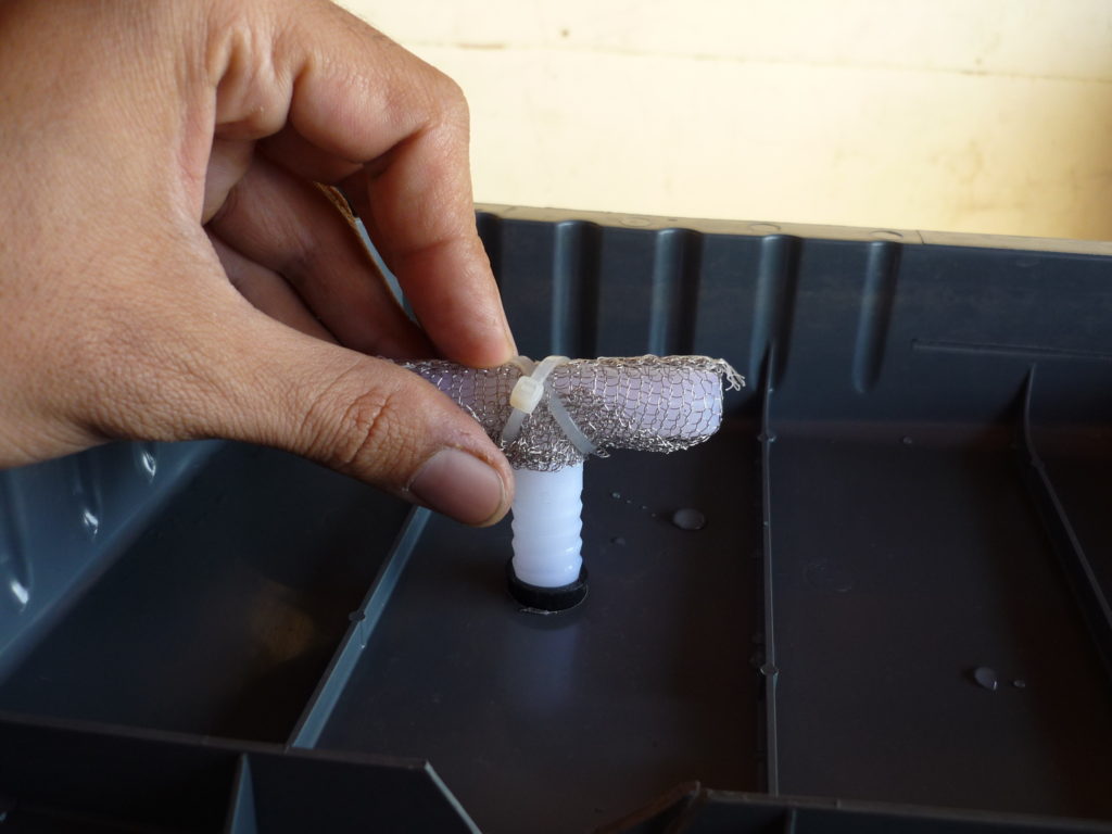 Original Garden Pool close-up of a half-inch barbed T fitting with stainless-steel mesh covering the two upper openings