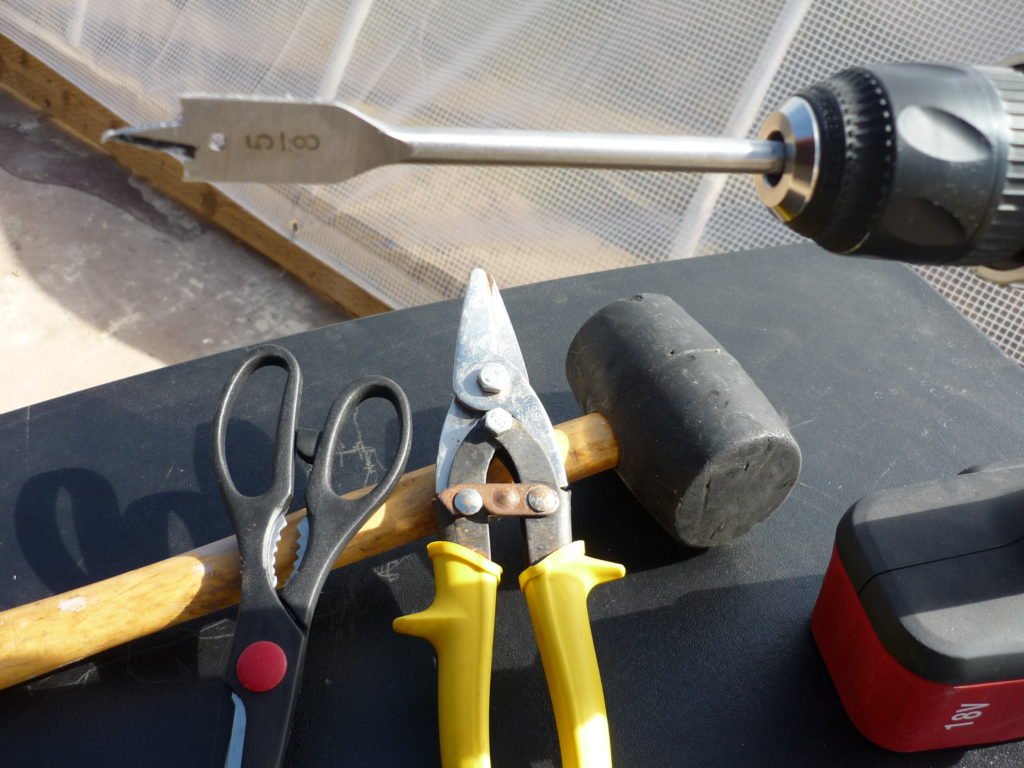 The original Garden Pool Shelfponics tools laid out: rubber mallet, cordless drill, tin snips and utility scissors